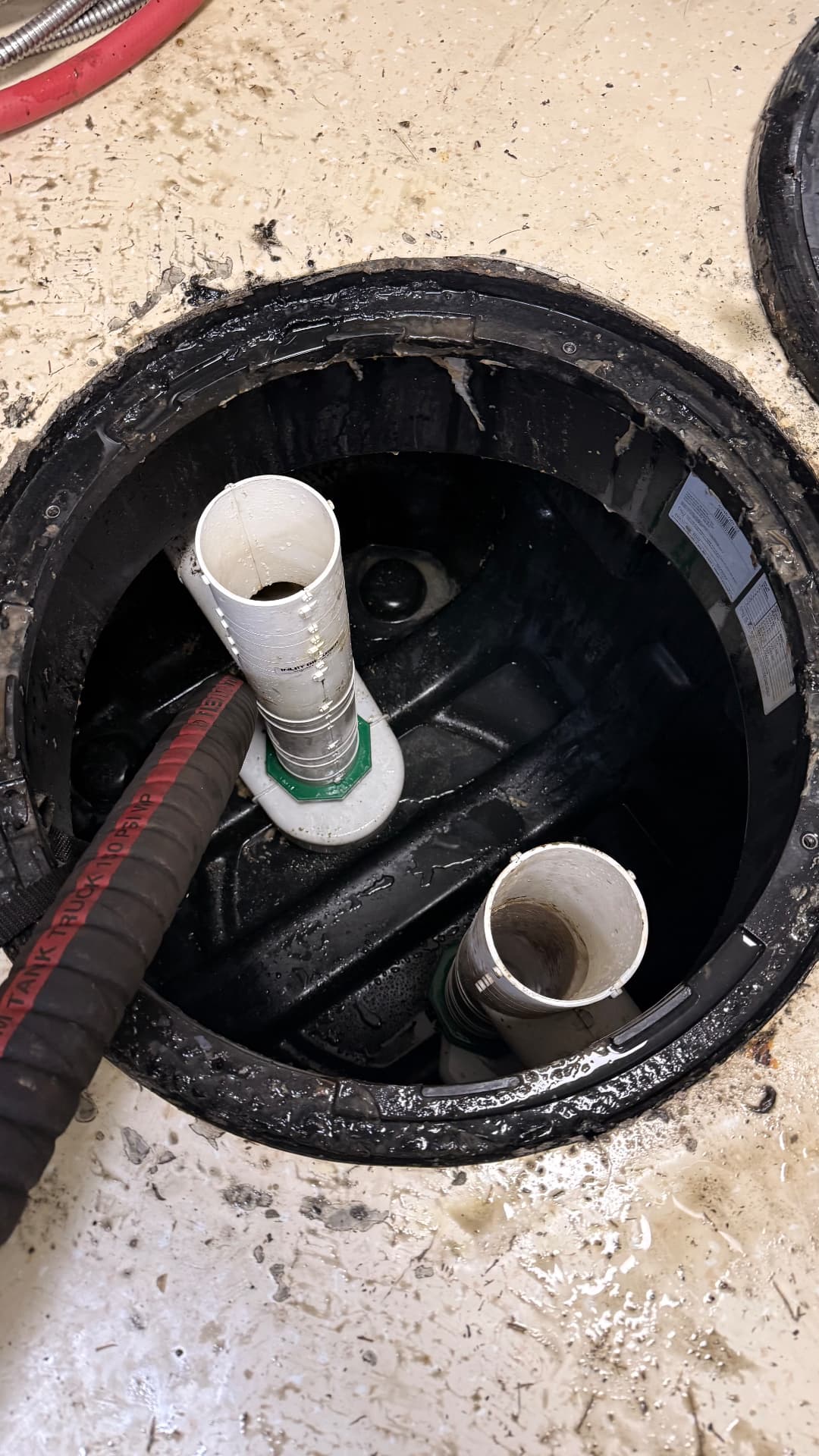 The same grease trap after cleaning, emptied and rinsed with the suction hose inside the tank